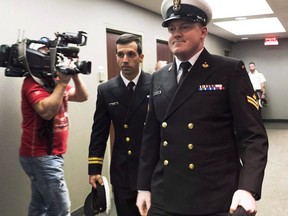 Accused Master Seaman Daniel Cooper, right, arrives for his standing court martial case in Halifax on Sept. 26, 2017.