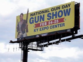 Seventeen crosses bearing the names and ages of those killed in last month's shooting at Marjory Stoneman Douglas High School in Parkland, Fla., were hung overnight from a Louisville billboard that advertises a local gun show on Sunday, March 11.