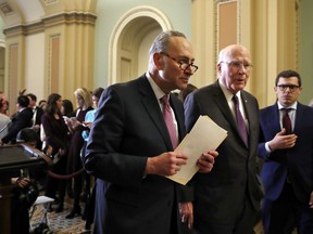 Senate Minority Leader Sen. Chuck Schumer of N.Y., centre, walks with Sen. Patrick Leahy, D-Vt., right, as they leave a news conference with Democratic leaders, Tuesday, March 20, 2018, on Capitol Hill in Washington. (AP Photo/Jacquelyn Martin)