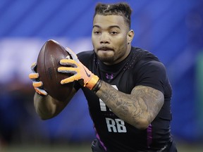 In this Friday, March 2, 2018, file photo, LSU running back Derrius Guice runs a drill during the NFL scouting combine in Indianapolis. (AP Photo/Darron Cummings, File)