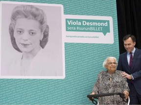 Finance Minister Bill Morneau puts his hand on the shoulder of Wanda Robson, the sister of Viola Desmond, as it is announced Desmond will be featured on Canadian currency during a ceremony in Gatineau, Quebec on Thursday December 8, 2016.