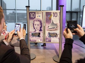 People take photos of the new $10 bank note featuring Viola Desmond following the bill's unveiling in Halifax on Thursday, March 8, 2018.