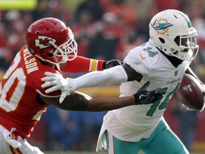 In this Dec. 24, 2017, file photo, Miami Dolphins wide receiver Jarvis Landry (14) runs away from Kansas City Chiefs defensive back Steven Nelson in Kansas City, Mo.