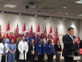 Ontario Finance Minister Charles Sousa with health-care professionals at a hospital funding announcement in Toronto on March 22, 2018. (Photo courtesy of Hayley Cooper, NEWSTALK 1010)