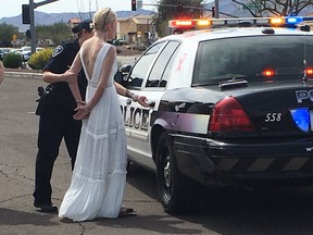 This photo provided by the Marana Police Department, in Arizona, shows 32-year-old Amber Young during her arrest on suspicion of impaired driving, Monday, March 12, 2018, in southern Arizona. Police say Young became involved in a car crash in Marana as she was driving to her wedding. One person suffered minor injuries in the three-vehicle crash. (Marana Police Department via AP)