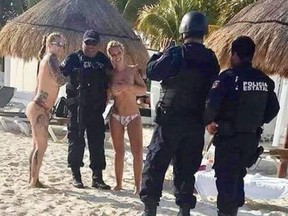 Three state police officers in Mexico's Caribbean coast state of Quintana Roo face administrative charges after photos posted on social media showed policemen posing for pictures with topless bathers. (Twitter/Noticaribe)