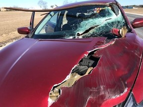 Emergency crews respond to a car with a pole pierced through it in Elgin County, Ont. on Monday Mar. 26, 2018.