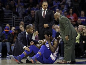 Philadelphia 76ers' Joel Embiid, centre, lies on the court after an injury against the New York Knicks, Wednesday, March 28, 2018, in Philadelphia. (AP Photo/Matt Slocum)