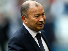 In this March 10, 2018 file photo, England's head coach Eddie Jones gestures as he watches his team warm up prior to the start of the Six Nations rugby union match between France and England at the Stade de France stadium in Saint-Denis, outside Paris