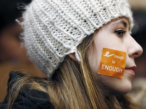 Helena Cameron, 15, of Medford, Mass., listens to speeches during a rally in St. Paul's Cathedral in Boston before a student march to the Statehouse, Wednesday, March 14, 2018. (AP Photo/Michael Dwyer)