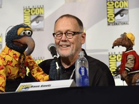 FILE - In this July 11, 2015 file photo, puppeteer Dave Goelz, center, appears with Muppet characters Gonzo, left, and Rizzo the Rat attend "The Muppets" panel at Comic-Con International in San Diego. Goelz is one of many Muppet artists shedding light on their creative processes and their characters' secret backstories in a new documentary, "Muppet Guys Talking," available online Friday.