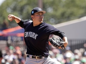 New York Yankees pitcher Masahiro Tanaka throws in the first inning of a spring baseball exhibition game against the Detroit Tigers, Saturday, March 17, 2018, in Lakeland, Fla.