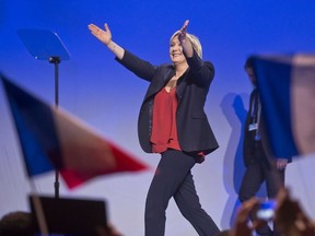 Far-right leader and candidate for the 2017 French presidential election Marine Le Pen acknowledges applauses as she arrives on stage for a meeting in Marseille, southern France, Wednesday, April 19, 2017.