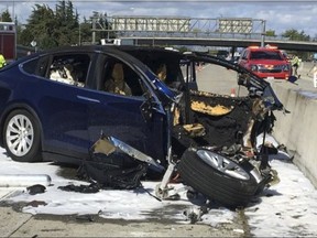 In this Friday March 23, 2018 photo provided by KTVU, emergency personnel work a the scene where a Tesla electric SUV crashed into a barrier on U.S. Highway 101 in Mountain View, Calif.(KTVU via AP)