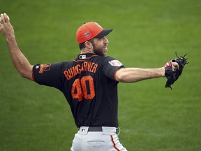 In this Feb. 15, 2018 file photo, San Francisco Giants' Madison Bumgarner throws during a spring training practice in Scottsdale, Ariz.