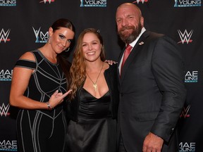 WWE Chief Brand Officer Stephanie McMahon, MMA fighter Ronda Rousey and WWE Executive Vice President of Talent, Live Events and Creative Paul 'Triple H' Levesque appear on the red carpet of the WWE Mae Young Classic on September 12, 2017 in Las Vegas, Nevada.