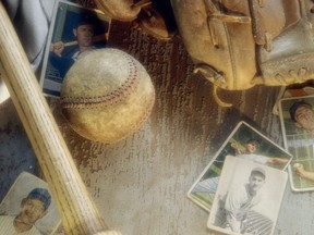 In this stock photo, old baseball cards are seen with equipment.