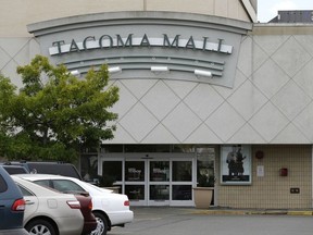 In this Sept. 7, 2016 file photo, cars are parked near an entrance to the Tacoma Mall in Tacoma, Wash. A Washington state teenager who was pulled from her bicycle in the mall parking lot in 2014 and shocked with a stun gun by an off-duty police officer working security was awarded $500,000 in federal court Thursday, March 22, 2018. The teen's brother was awarded $50,000.