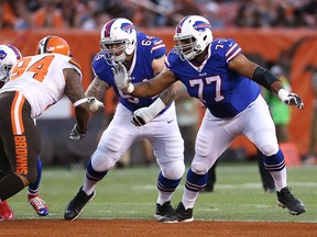 In this Aug. 20, 2015, file photo, Buffalo Bills tackle Cordy Glenn (77) and Richie Incognito (64) work against Cleveland Browns defensive tackle Randy Starks (94) in Cleveland. (AP Photo/Ron Schwane, File)