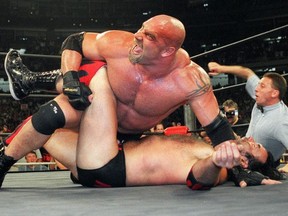 FILE - In this July 6, 1998, file photo, World Championship Wrestling heavyweight champion Bill Goldberg puts Scott Hall to the mat during a match in Atlanta. Bill Goldberg found his toughest tag-team partner yet. "The Goldbergs." Goldberg is set to star in Wednesday's, March 21, 2018, episode. But the wrestling great has a bigger date ahead when he's inducted into the WWE Hall of Fame on WrestleMania weekend.
