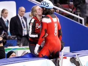 Canada's Charles Hamelin kisses his girlfriend Marianne St-Gelais after winning a gold medal at the Vancouver Olympics in 2010