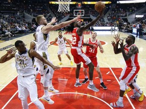 Hawks forward Taurean Prince (12) shoots past Pacers centre Domantas Sabonis (11) during the first half of an NBA game in Atlanta on Wednesday, Feb. 28, 2018.