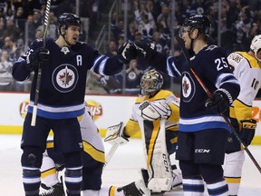 Winnipeg Jets' Mark Scheifele (55) and Paul Stastny (25) celebrate Scheifele's goal on Nashville Predators goaltender Pekka Rinne (35) during second period NHL hockey action in Winnipeg, Tuesday, February 27, 2018. THE CANADIAN PRESS/Trevor Hagan ORG XMIT: WPGT114