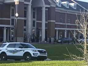 Authorities investigate the scene where a shooting occurred at Huffman High School, Wednesday, March 7, 2018, in Birmingham, Ala. Birmingham Interim Police Chief Orlando Wilson said at a news conference that authorities are seeking to determine whether the deadly shooting Wednesday at the Alabama high school was accidental or if a gun since recovered by investigators was intentionally discharged. (Carol Robinson/AL.com via AP)