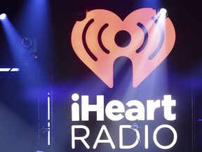 In this Nov. 7, 2017, file photo, the logo for iHeartRadio, owned by iHeartMedia, Inc., is shown during an album release party with Maroon 5 in Burbank, Calif.  (Richard Shotwell/Invision/AP, File)