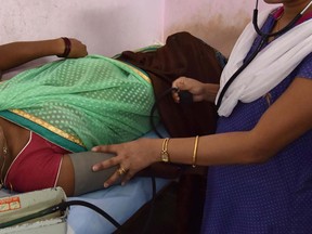In this May 9, 2017 file photo, an Indian doctor examines an expectant mother during a free halth clinic for pregnant women at the Maternity and Child Welfare Hospital at Dhirenpara in Guwahati. (BIJU BORO/AFP/Getty Images)