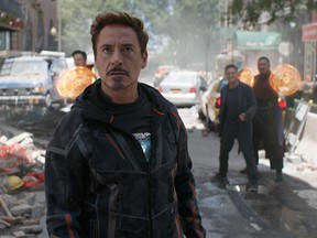 Tony Stark/Iron Man (Robert Downey Jr.) w/ Doctor Strange (Benedict Cumberbatch), Bruce Banner (Mark Ruffalo) and Wong (Benedict Wong) in the background L to R. Photo: Film Frame.