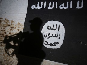 A member of the Iraqi forces walks past a mural bearing the logo of the ISIS group on March 1, 2017, in the village of Albu Sayf, on the southern outskirts of Mosul.
(AHMAD AL-RUBAYE/AFP/Getty Images)