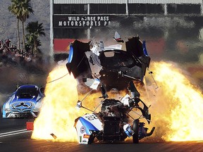 In this Sunday, Feb. 25, 2018, photo, the engine in Funny Car driver John Force's car blows up in an elimination round against Jonnie Lindberg during the NHRA Arizona Nationals drag races in Chandler, Ariz.  (Will Lester/Los Angeles Daily News via AP)