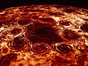 This composite image provided by NASA, derived from data collected by the Jupiter-orbiting Juno spacecraft, shows the central cyclone at the planet's north pole and the eight cyclones that encircle it.