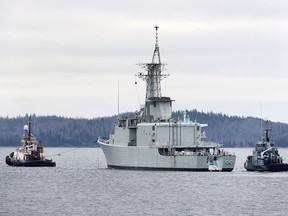Athabaskan is towed by Atlantic Towing Limited's Atlantic Larch, left, and followed by the navy tug CFAV Glenside, from the harbour in Halifax on Thursday, March 29, 2018.