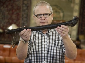 Grant Gardner of Gardner Galleries displays a shillelagh once owned by Robert Donnelly of Lucan, Ontario's infamous Donnelly family in London, Ont. on Tuesday March 27, 2018. (Derek Ruttan/Postmedia Network)