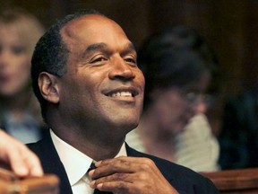 O.J. Simpson adjusting his tie before the jury selection of his trial at the Miami circuit court in Miami.