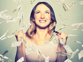 happy woman pumping fists celebrates success under money rain