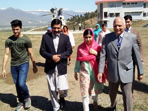 Pakistani activist and Nobel Peace Prize laureate Malala Yousafzai (C), arrives along with her father Ziauddin Yousafzai (2L), brother Atal Yousafzai (L) and the principal of all-boys Swat Cadet College Guli Bagh, during her hometown visit, some 15 kilometres outside of Mingora, on March 31, 2018. (ABDUL MAJEED/AFP/Getty Images)