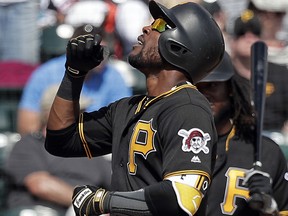 Pittsburgh Pirates' Starling Marte points upward as he crosses home plate after hitting a home run against the Atlanta Braves Monday, March 5, 2018, in Kissimmee, Fla. (AP Photo/John Raoux)