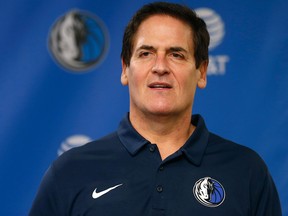 Dallas Mavericks owner Mark Cuban stands on stage before Cynthia Marshall, new interim CEO of the team, is introduced during a news conference on Feb. 26, 2018