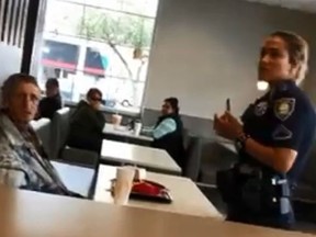 In a viral video, an unnamed police officer is seen confronting a homeless man at a McDonald's. The homeless man was later kicked out (Facebook/Yossi Gallo)