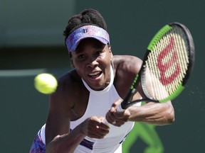 Venus Williams returns to Kiki Bertens, of the Netherlands, during the Miami Open tennis tournament, Sunday, March 25, 2018, in Key Biscayne, Fla.