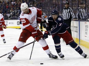 Detroit Red Wings' Mike Green, left, and Columbus Blue Jackets' Artemi Panarin fight for the puck Friday, March 9, 2018, in Columbus, Ohio. (AP Photo/Jay LaPrete)