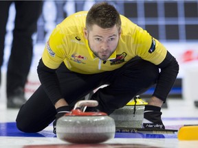 Skip Mike McEwen, from Winnipeg, watches a rock enter the house during the Olympic curling trials action Wednesday, December 6, 2017 in Ottawa. (THE CANADIAN PRESS/Adrian Wyld)