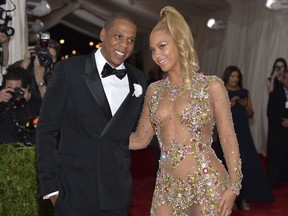 FILE  - In this May 4, 2015, file photo, Jay Z, left, and Beyonce arrive at The Metropolitan Museum of Art's Costume Institute benefit gala celebrating "China: Through the Looking Glass" in New York. The pair have announced they'll hit the road together this summer and fall for a stadium tour. The hip-hop super couple will kick off their "On the Run II" tour June 6, 2018, in Cardiff, Wales. The tour will hit 15 cities across the United Kingdom and Europe and 21 cities in North America, including Boston, Detroit, New Orleans, Houston, Los Angeles, Atlanta and Miami.