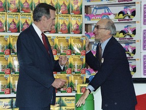 In this Jan. 7, 1992, file photo, President George H. Bush, left, listens to Toys R Us Chairman Charles Lazarus, right, as he visits the toy chain's second store to open in Japan. (AP Photo, File)
