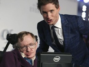 FILE - In this Tuesday, Dec. 9, 2014 file photo actor Eddie Redmayne, right, and Professor Stephen Hawking arrive on the blue carpet for the UK premiere of The Theory Of Everything at the Odeon in Leicester Square, central London. Hawking, whose brilliant mind ranged across time and space though his body was paralyzed by disease, has died, a family spokesman said early Wednesday, March 14, 2018.