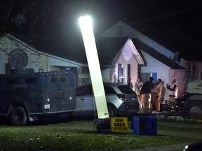 Law enforcement officials respond to the scene of a shooting where officer Christopher Ryan Morton was killed and others wounded as they responded to a 911 call on Tuesday evening, March 6, 2018, in Clinton, Mo.