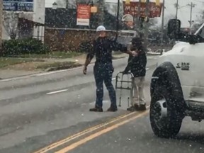 A viral video shows a Good Samaritan stop in the middle of traffic to help an elderly man across the street. (Facebook)